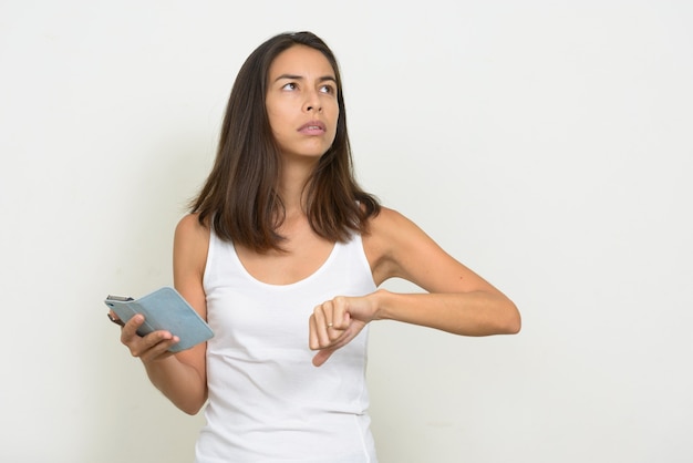 Portrait of stressed multi ethnic woman using phone and giving thumbs down