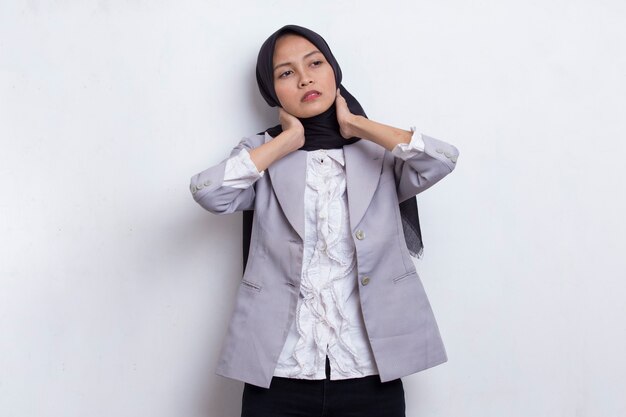 Portrait of stressed tired sick asian muslim woman with headache on white background