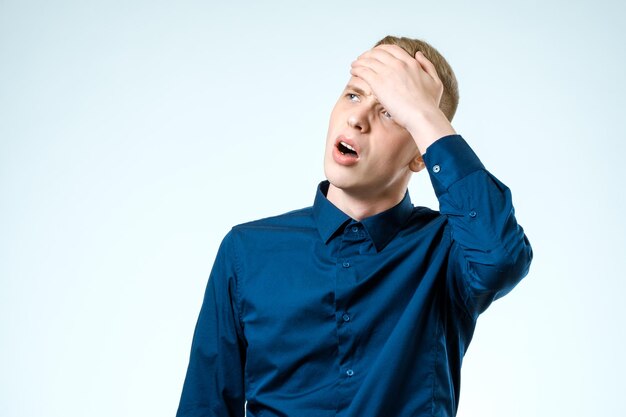 Portrait of stressed young man hands on head Isolated background Negative human emotion and facial expression