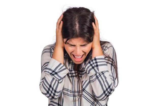 Portrait of stressed young woman suffering headache in studio.