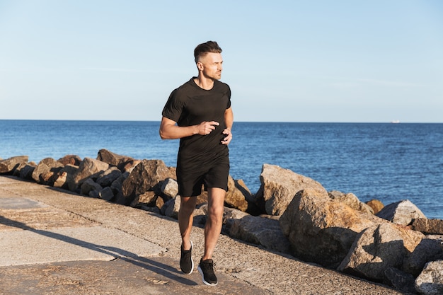 Portrait of a strong sportsman jogging