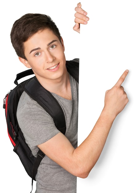 Portrait of Student behind Blank Wall Pointing Finger