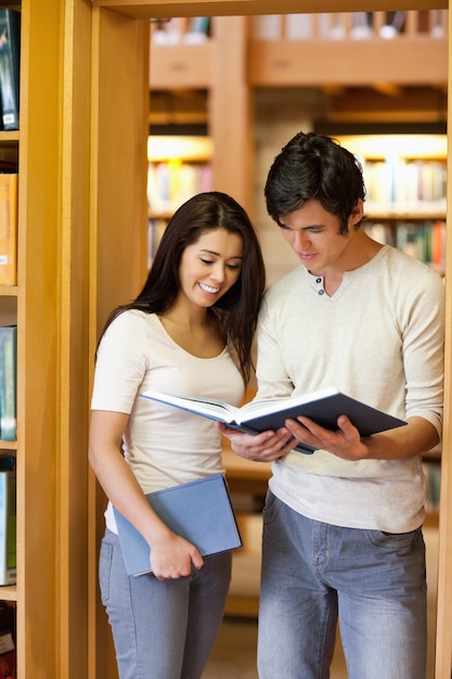 Portrait of students looking at a book