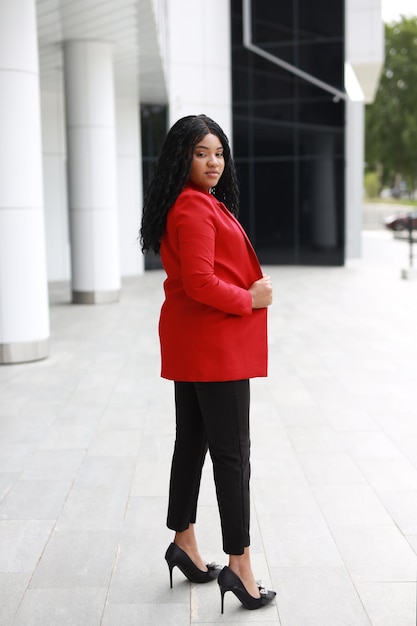 portrait of stylish african american woman in red jacket