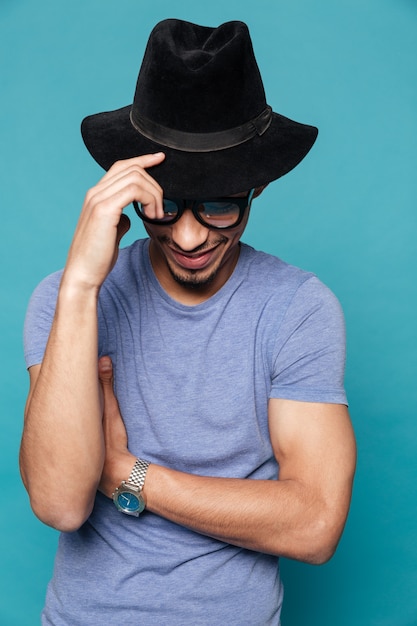 Portrait of a stylish afro american man in hat posing