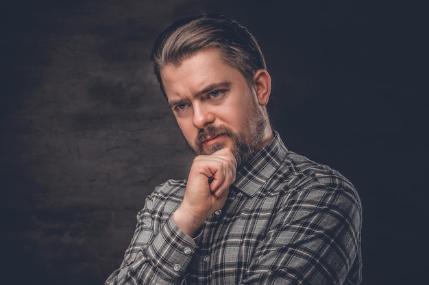 Portrait of a stylish bearded male dressed in a plaid fleece shirt