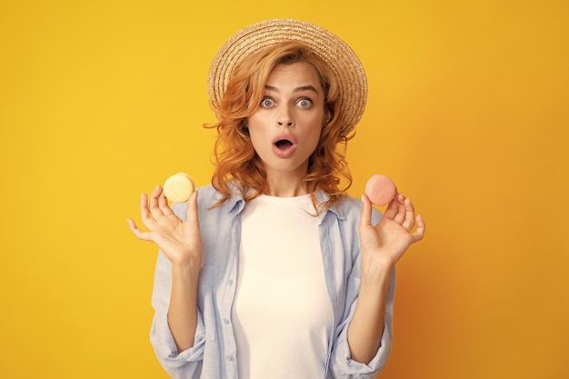 Portrait of stylish beautiful pretty cute she her girl with sweets cookies macaroon isolated on yellow background