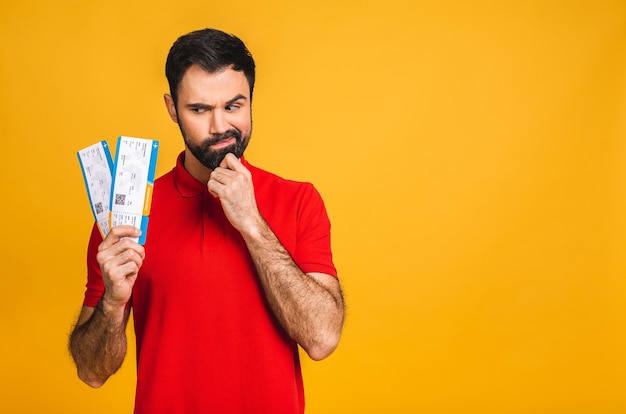 Portrait of stylish handsome bearded young man, isolated over yellow background.