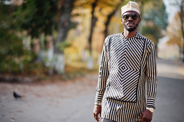 Portrait of stylish man at hat and sunglasses