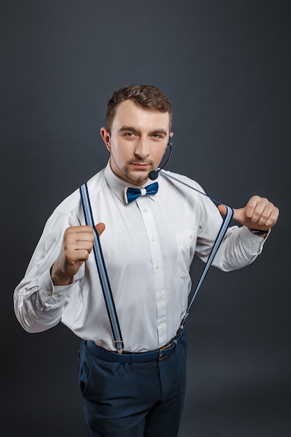 Portrait of stylish man in suspenders and bowtie