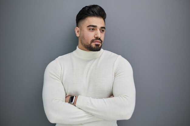 Portrait of stylish middle aged man posing on gray background