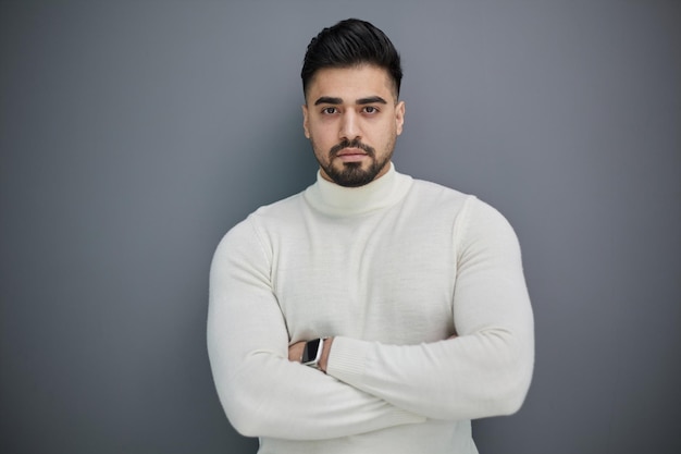 Portrait of stylish middle aged man posing on gray background