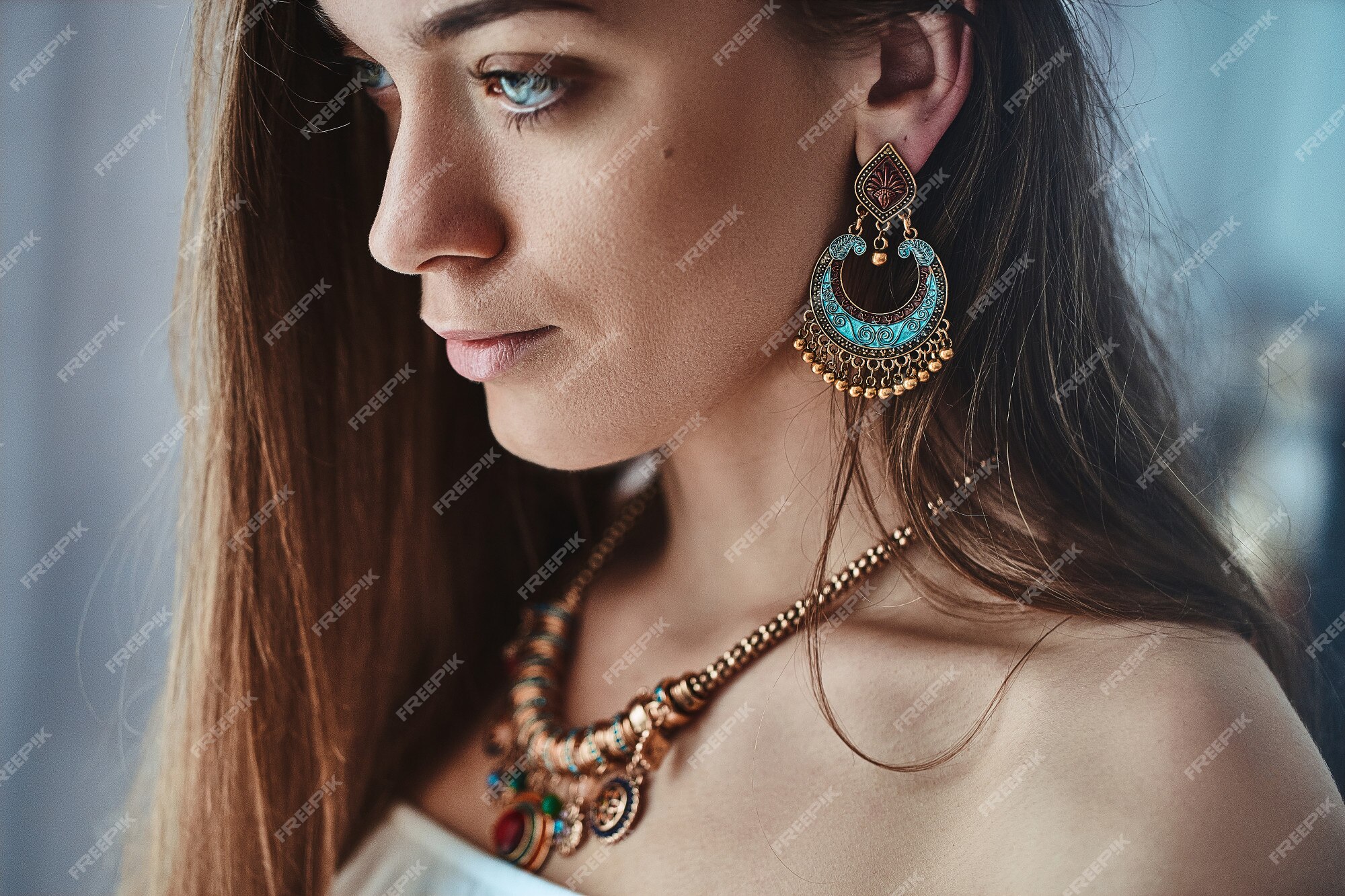 Premium Photo  Portrait of stylish sensual brunette boho woman with  beautiful eyes wearing big earrings and gold necklace. fashionable indian  hippie gypsy bohemian outfit with jewelry details accessories