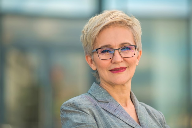 Portrait of stylish woman in a suit and glasses