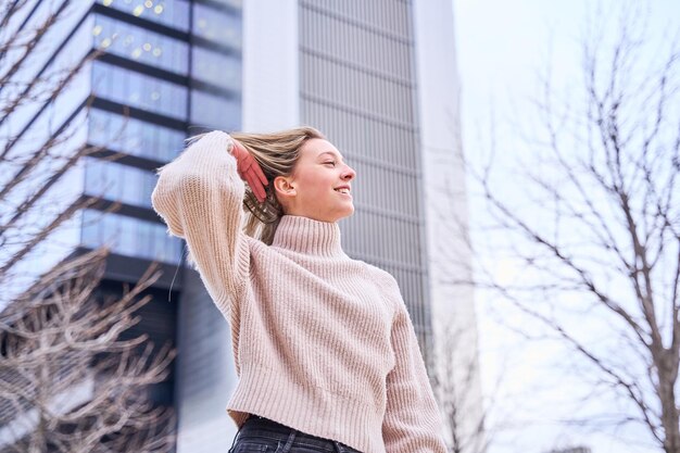 portrait of a stylish woman touching her blonde hair