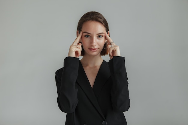 Portrait of a stylish young lady on a gray background Fashion shot