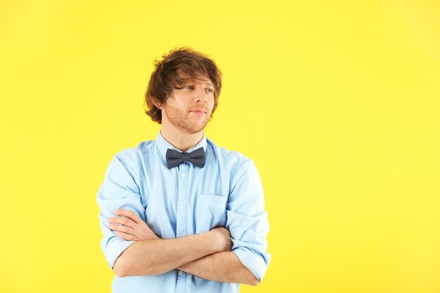 Portrait of stylish young man on color background