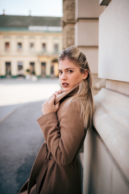 Portrait of stylish young woman in the town street.