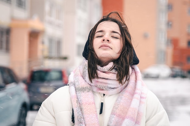 Portrait of a stylish young woman in winter outside blurred background