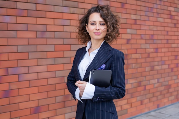 Портрет успешной бизнес-женщины перед современным деловым зданием Молодой менеджер