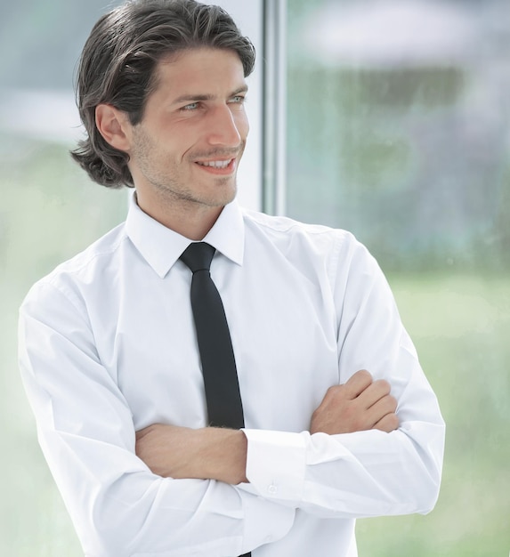 Portrait of successful businessman on background of office