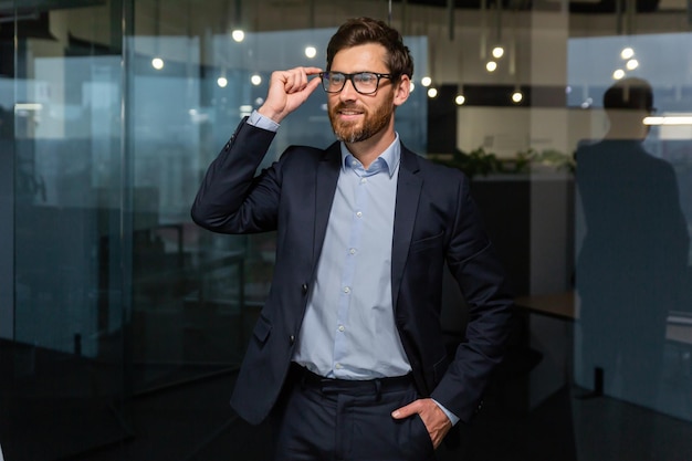 Portrait of successful businessman mature boss in business suit man working inside office at work in