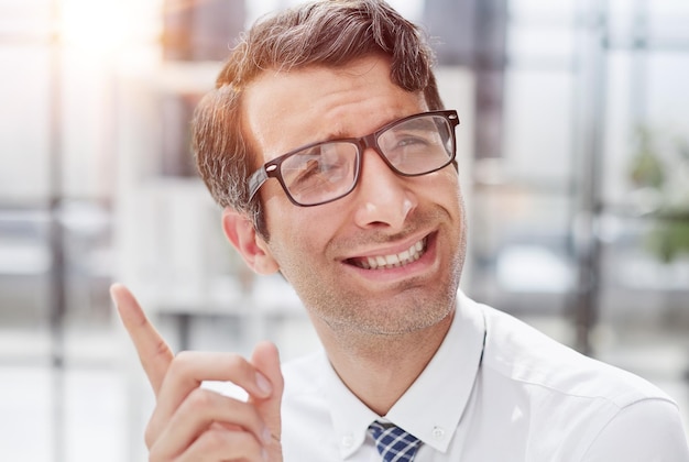 Portrait of a successful businessman in the office a man in a shirt is looking for ideas