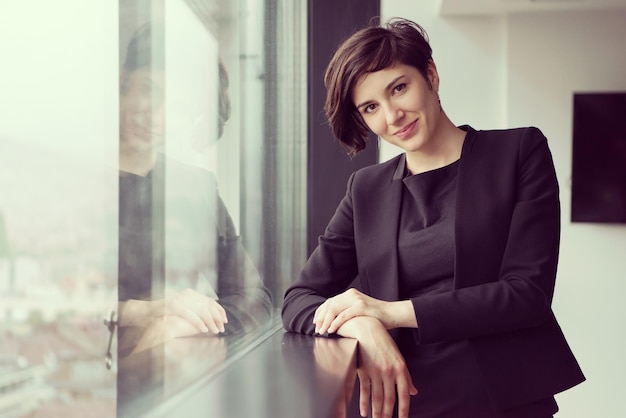 Portrait Of Successful Businesswoman by the window Entrepreneur At Busy startup Office