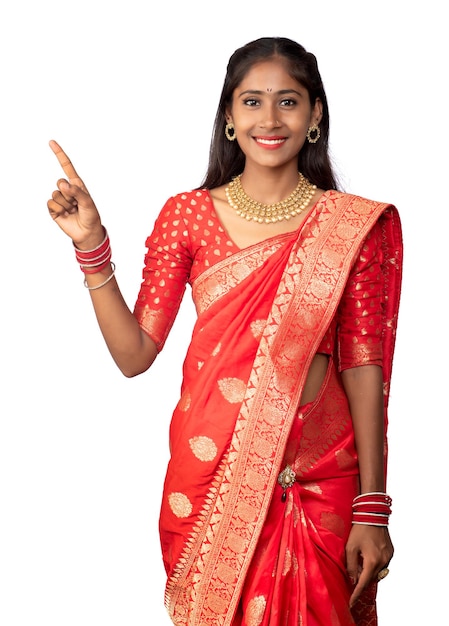 Portrait of a successful cheerful young girl pointing and presenting something with a hand or finger with a happy smiling face