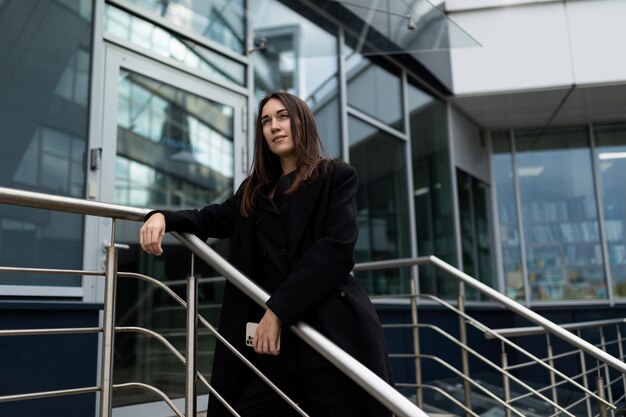 Portrait of a successful female leader next to the office center