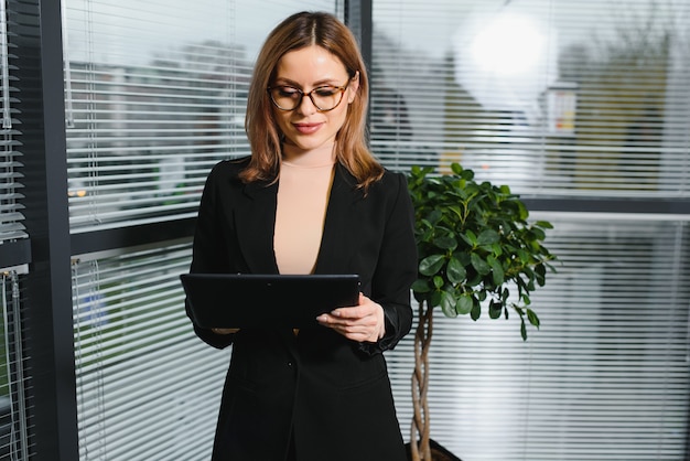 Portrait of successful female sitting in office