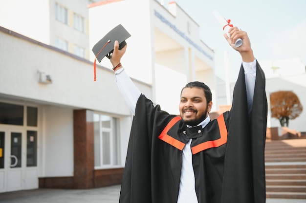 Portrait of successful indian student in graduation gown