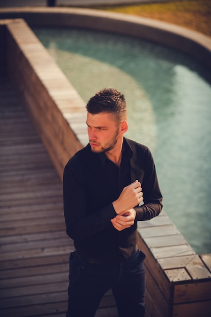 Portrait of a successful man beside the private pool