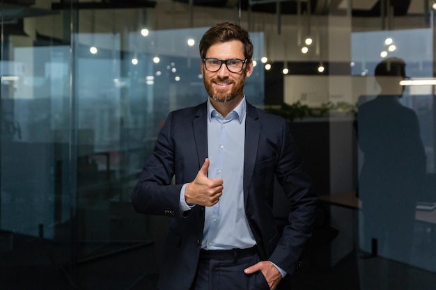 Portrait of successful mature businessman boss manager in business suit glasses and beard looking at