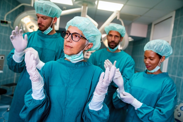 Portrait of a successful medical surgeon team inside operating room, ready to work in hospital