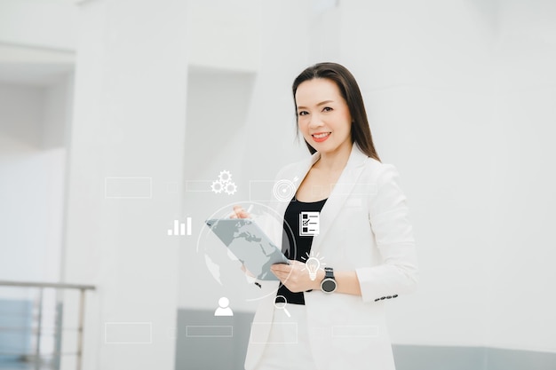 Portrait Of Successful A middle-aged Asian businesswoman Holding tablet smiling to camera