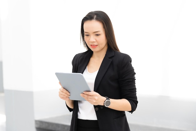 Portrait Of Successful A middle-aged Asian businesswoman Holding tablet smiling to camera