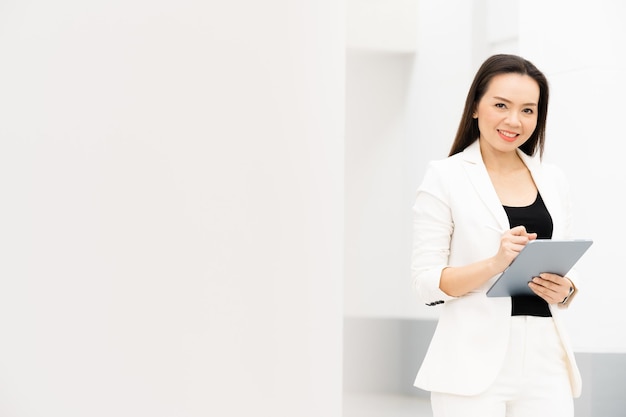 Portrait Of Successful A middle-aged Asian businesswoman Holding tablet smiling to camera