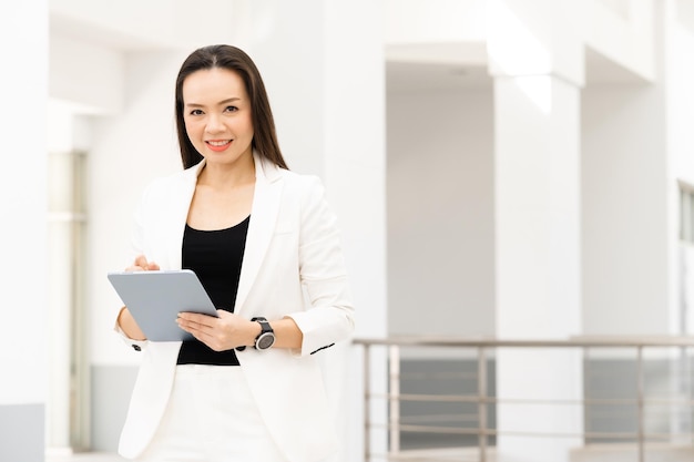 Portrait Of Successful A middle-aged Asian businesswoman Holding tablet smiling to camera