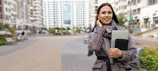 Portrait of a successful woman entrepreneur on the background of a residential area