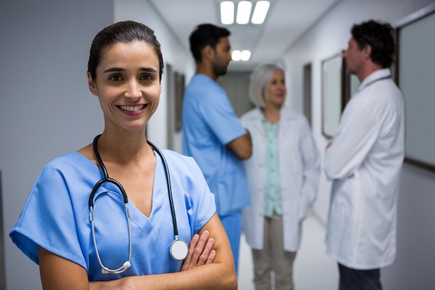 Portrait of surgeon holding file in corridor