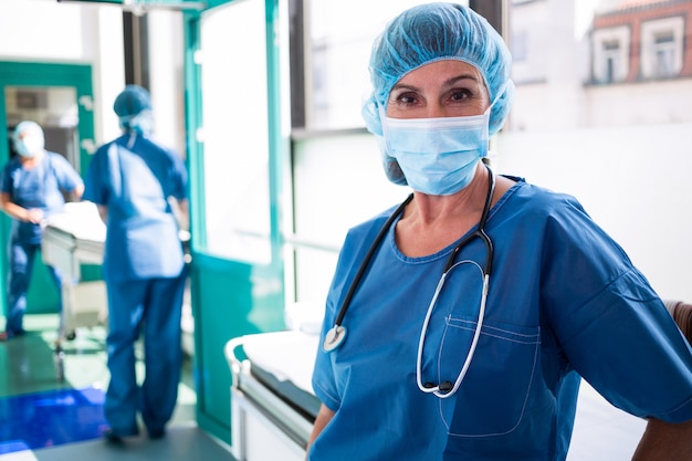 Portrait of surgeon standing in corridor