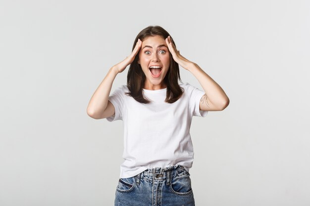 Portrait of surprised attractive girl looking excited and smiling amazed.