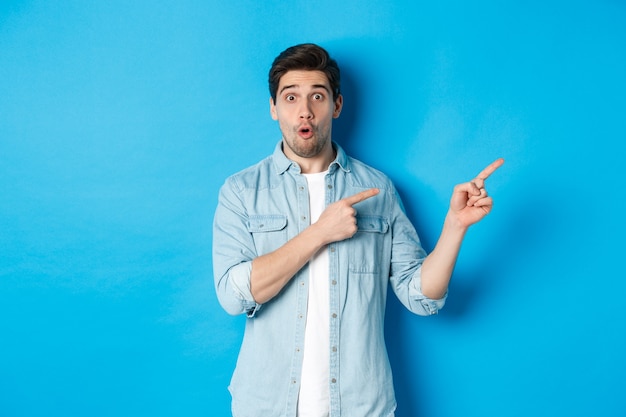 Portrait of surprised bearded guy in casual outfit