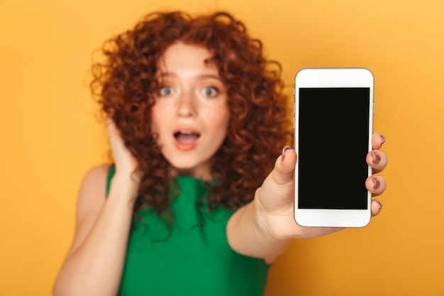 Portrait of a surprised redhead woman in dress