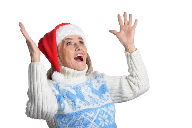 Portrait of surprised senior woman in Santa hat