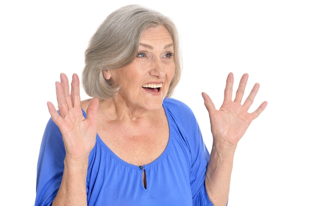 Portrait of surprised senior woman on white background