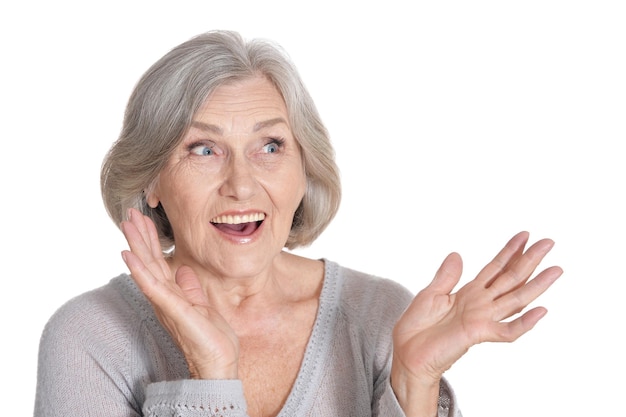 Portrait of surprised senior woman on white background