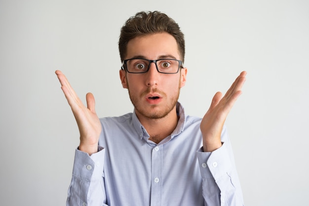 Portrait of surprised or shocked young businessman