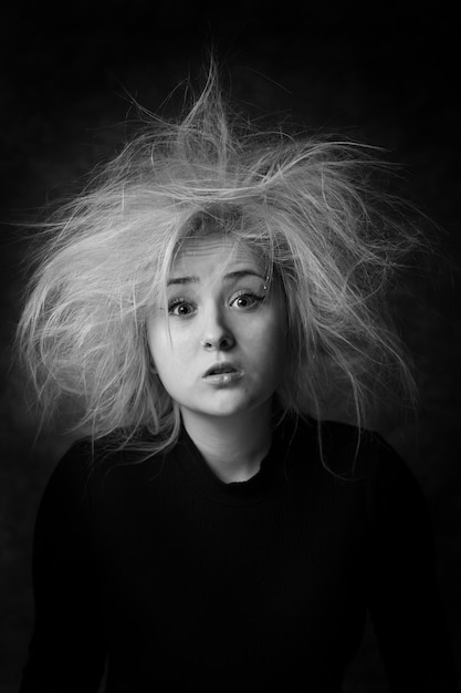 Portrait of surprised woman with wideopen eyes in black and white color Woman with disheveled hair